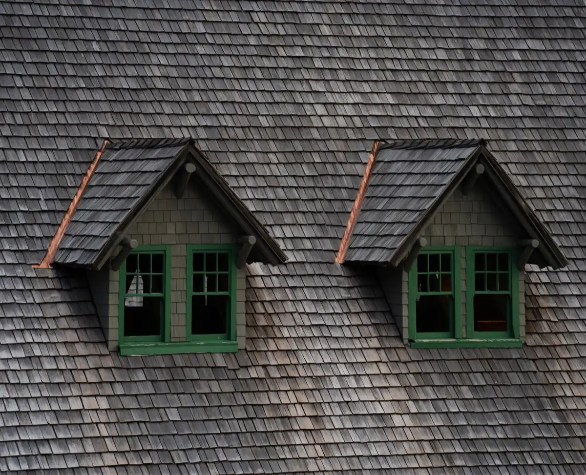 Dormers on a shingle roof in Pomona, CA, where step flashing and kickout flashing carry water past the walls